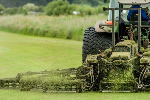A tractor being used to cut grass at a commercial turf growing farm. - Big Easy Grass Cutting